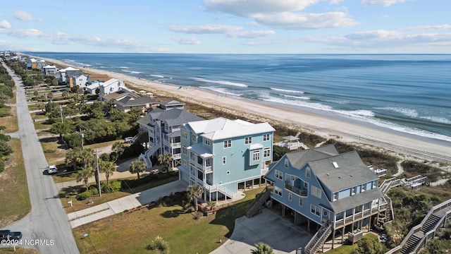 drone / aerial view featuring a view of the beach and a water view