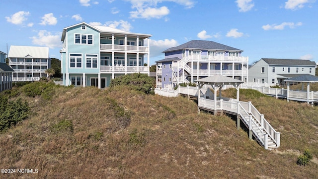 back of house featuring a balcony