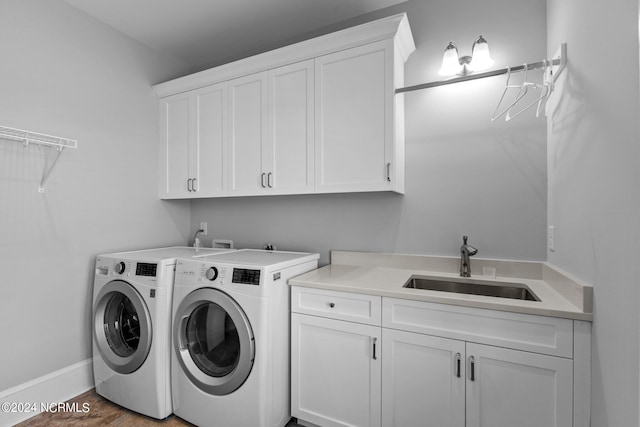 washroom featuring hardwood / wood-style flooring, separate washer and dryer, cabinets, and sink