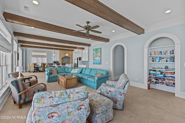 tiled living room with ceiling fan, beamed ceiling, and crown molding