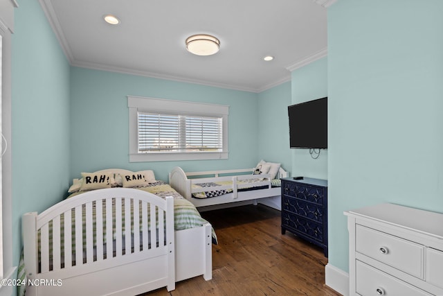 bedroom featuring ornamental molding and hardwood / wood-style flooring