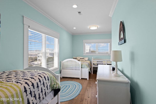 bedroom featuring ornamental molding and hardwood / wood-style floors