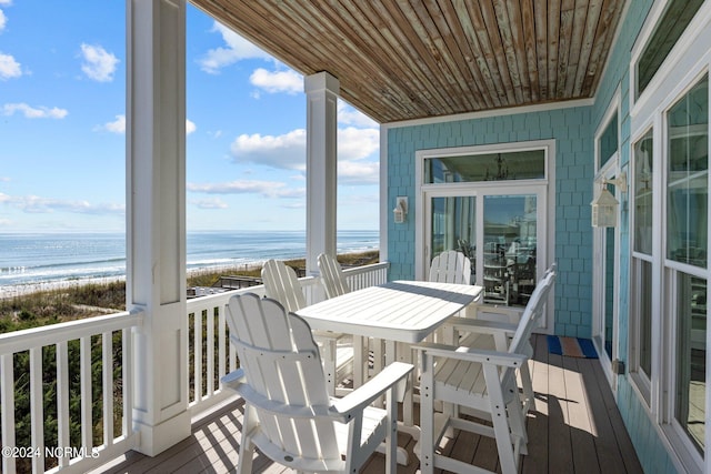 balcony featuring a water view and a beach view