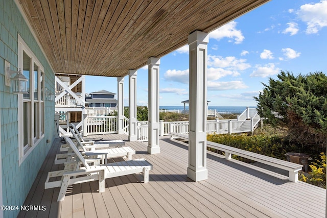 wooden deck featuring a water view