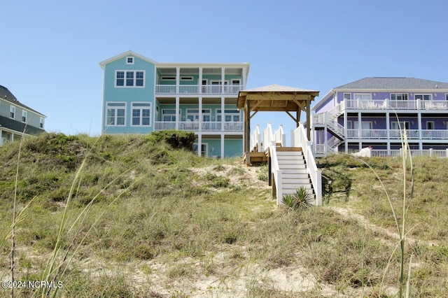 back of house featuring a balcony