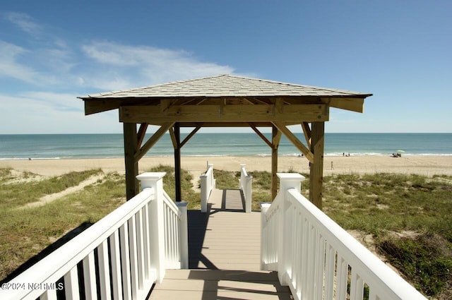 view of community featuring a water view, a gazebo, and a view of the beach