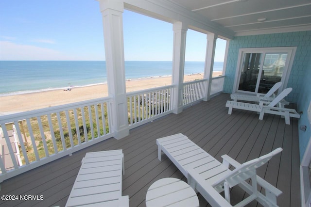 deck featuring a water view and a view of the beach