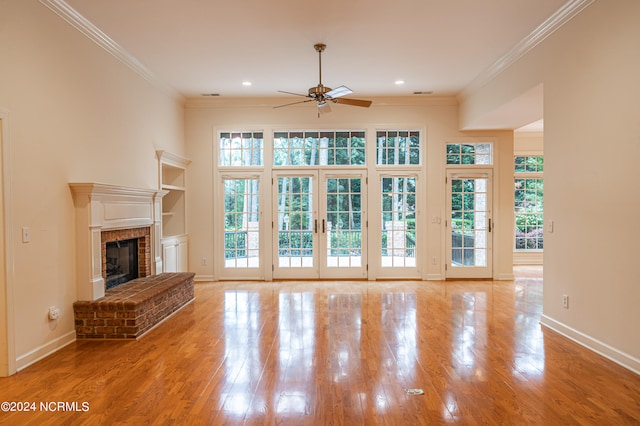 unfurnished living room featuring light hardwood / wood-style floors, plenty of natural light, and crown molding