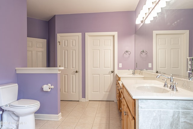 bathroom featuring toilet, vanity, and tile patterned floors