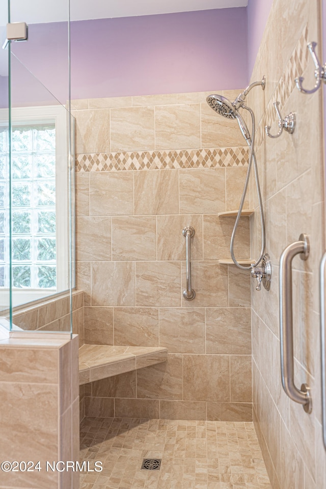 bathroom featuring a shower with door