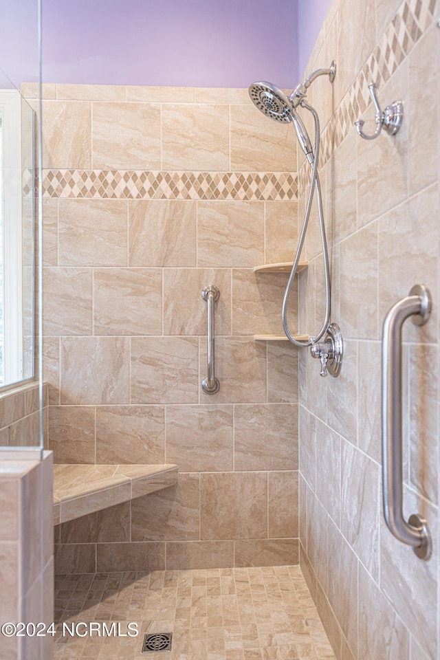 bathroom with a tile shower