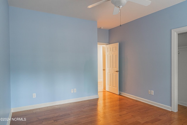 empty room featuring ceiling fan and hardwood / wood-style floors