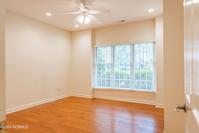 spare room with light hardwood / wood-style flooring and ceiling fan