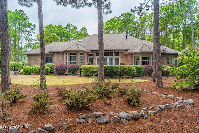 ranch-style home with a front lawn