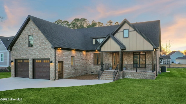 view of front of home with central air condition unit, covered porch, brick siding, concrete driveway, and a front yard