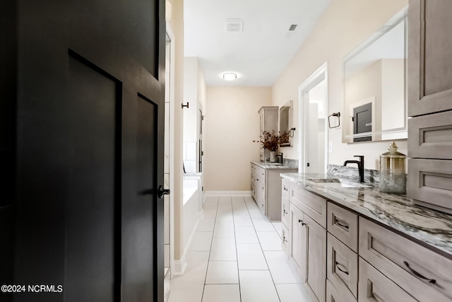 full bathroom featuring a shower, two vanities, a bathing tub, a sink, and tile patterned floors