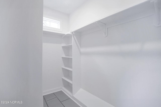 walk in closet with tile patterned flooring