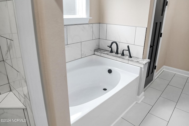 bathroom featuring a garden tub and tile patterned floors