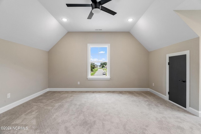 additional living space with vaulted ceiling, visible vents, and baseboards