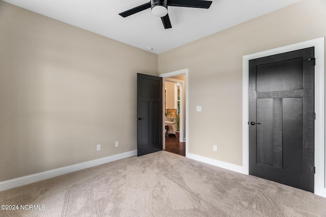 unfurnished bedroom with carpet floors, ceiling fan, and baseboards