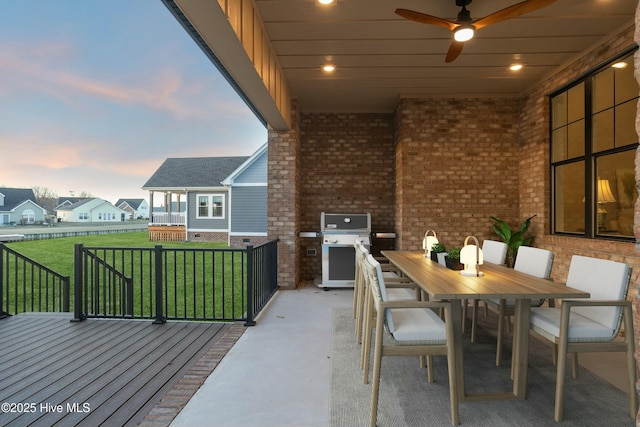 view of patio featuring a ceiling fan, outdoor dining area, a wooden deck, and area for grilling