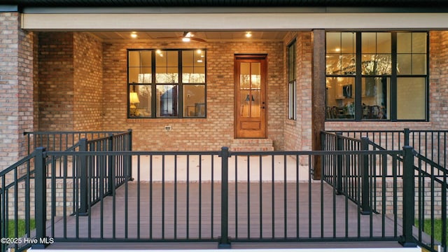 doorway to property featuring brick siding