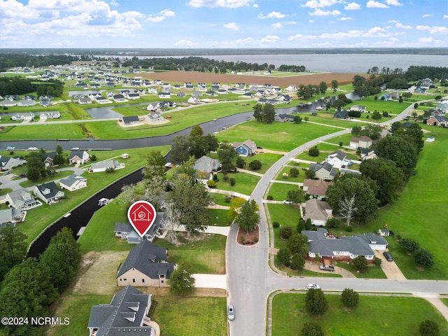 drone / aerial view featuring a water view and a residential view