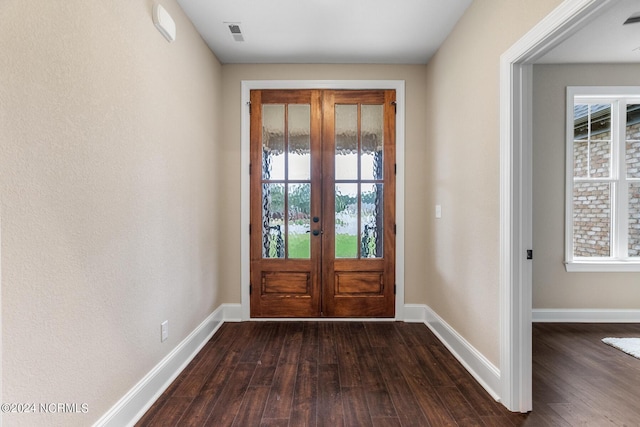 doorway featuring dark wood-style floors and baseboards