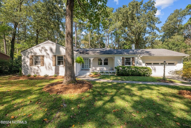 ranch-style house with a front yard and a garage