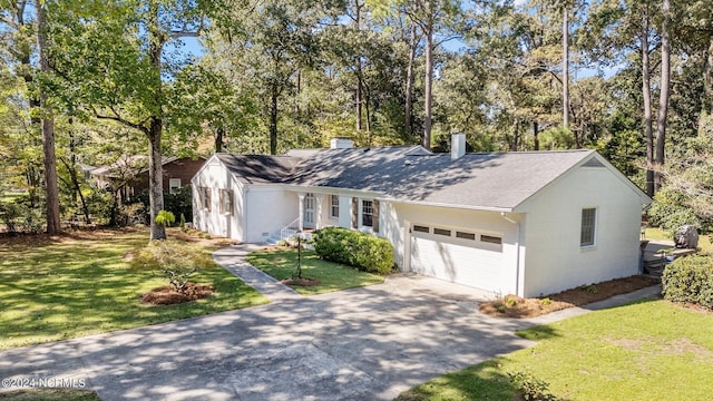 ranch-style home with a garage and a front lawn