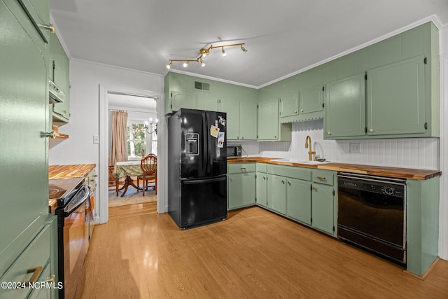 kitchen with crown molding, light hardwood / wood-style flooring, green cabinetry, sink, and black appliances