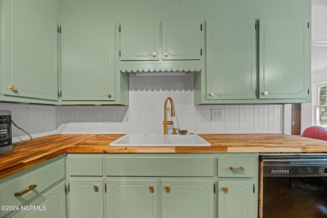 kitchen with dishwasher, sink, and wood counters