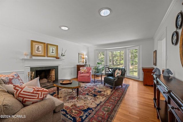 living room with crown molding and light hardwood / wood-style flooring