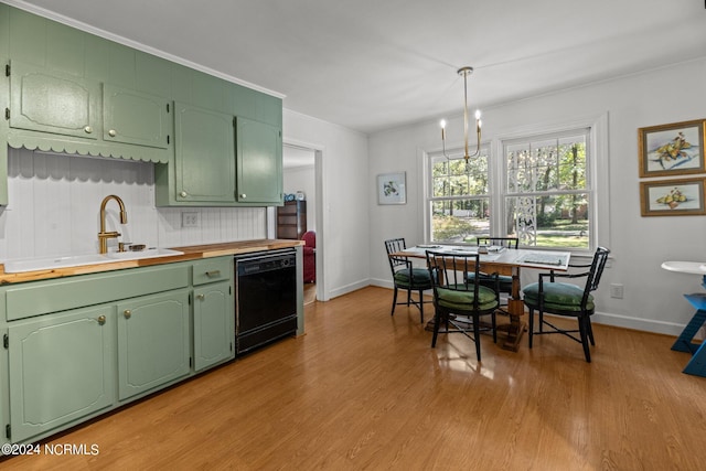 kitchen with green cabinetry, sink, light hardwood / wood-style floors, pendant lighting, and dishwasher