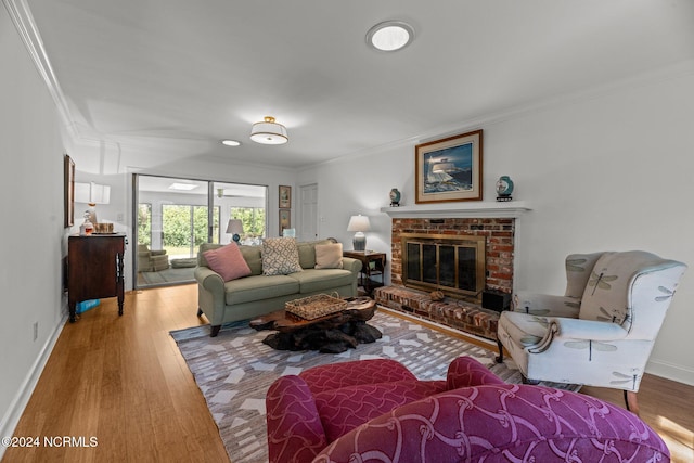 living room with a brick fireplace, crown molding, and hardwood / wood-style flooring