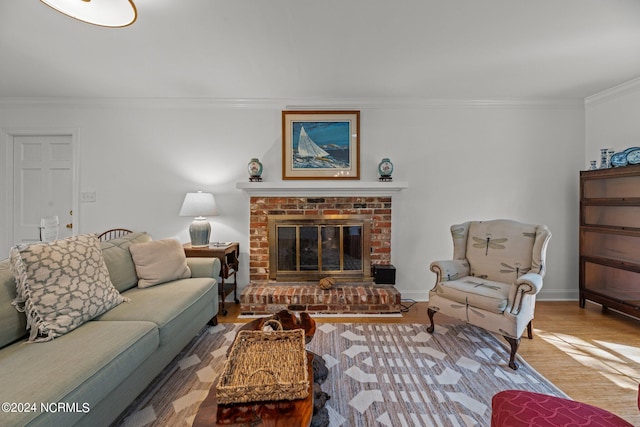 living room featuring a brick fireplace, crown molding, and wood-type flooring