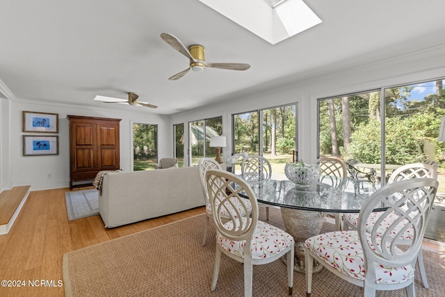 dining space with ceiling fan, ornamental molding, light hardwood / wood-style flooring, and a healthy amount of sunlight