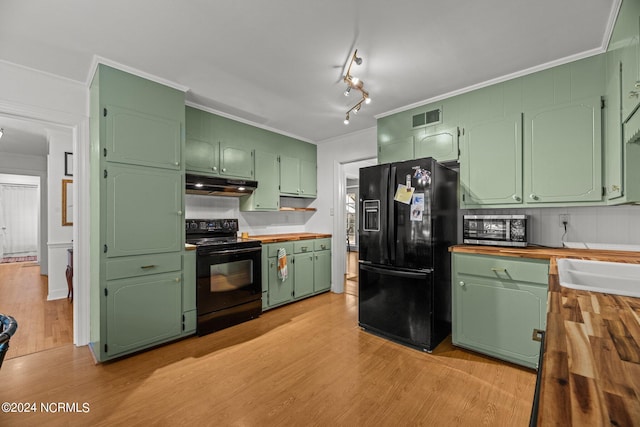 kitchen with green cabinetry, light hardwood / wood-style flooring, crown molding, and black appliances