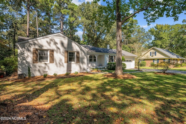 ranch-style home with a front lawn and a garage