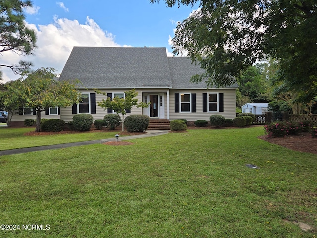 cape cod-style house featuring a front lawn