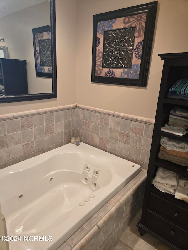 bathroom with tiled bath and tile patterned floors