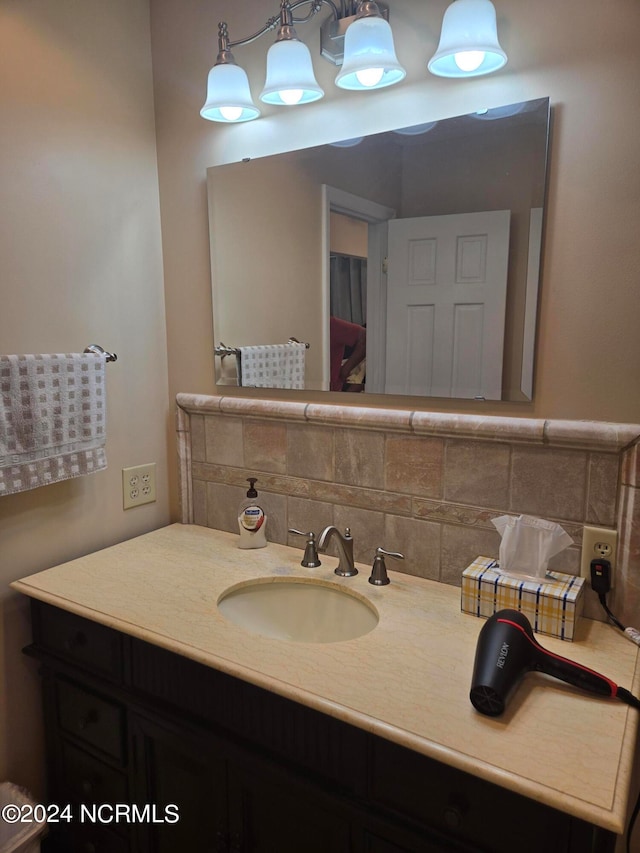 bathroom with decorative backsplash and vanity