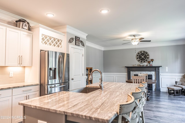 6 Eagle Dr, Foxfire Village, NC 27281 - kitchen with white cabinets, stainless steel refrigerator with ice dispenser, a sink, a ceiling fan, and a center island with sink