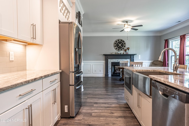 kitchen with ceiling fan, stainless steel appliances, dark hardwood / wood-style flooring, and white cabinetry