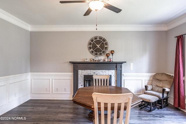 sitting room with ceiling fan, ornamental molding, a fireplace, and dark wood-type flooring