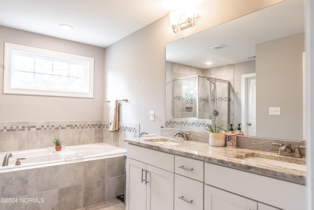 bathroom featuring independent shower and bath and vanity