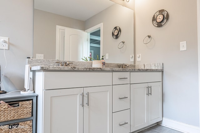 bathroom with tile patterned floors and vanity