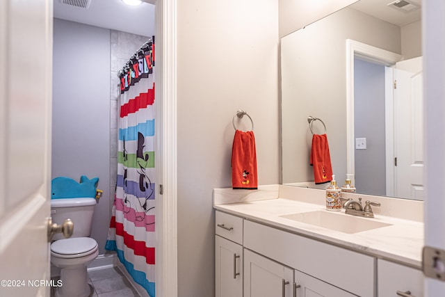 bathroom featuring a shower with curtain, vanity, toilet, and tile patterned floors