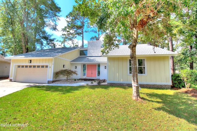 ranch-style house featuring a front yard and a garage