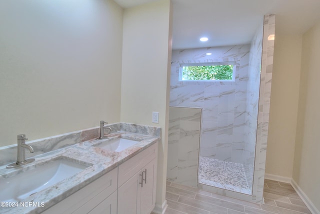 bathroom with vanity and tiled shower